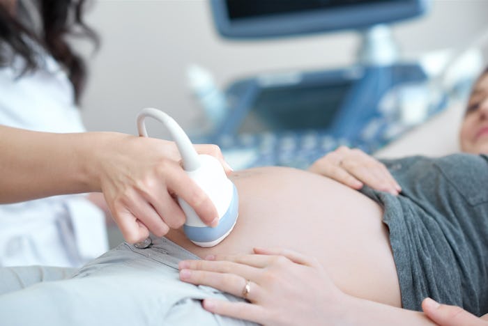 A pregnant woman getting an ultra sound in order to check if her baby is breech