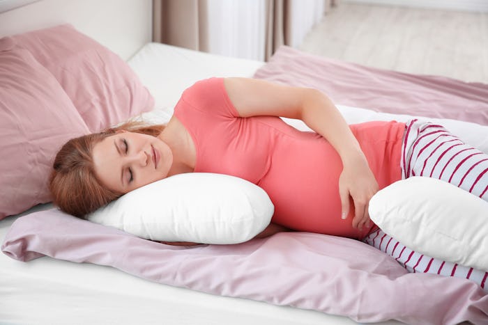 Experts recommend using a lot of pillows to help your back and pelvic pain during sleep.