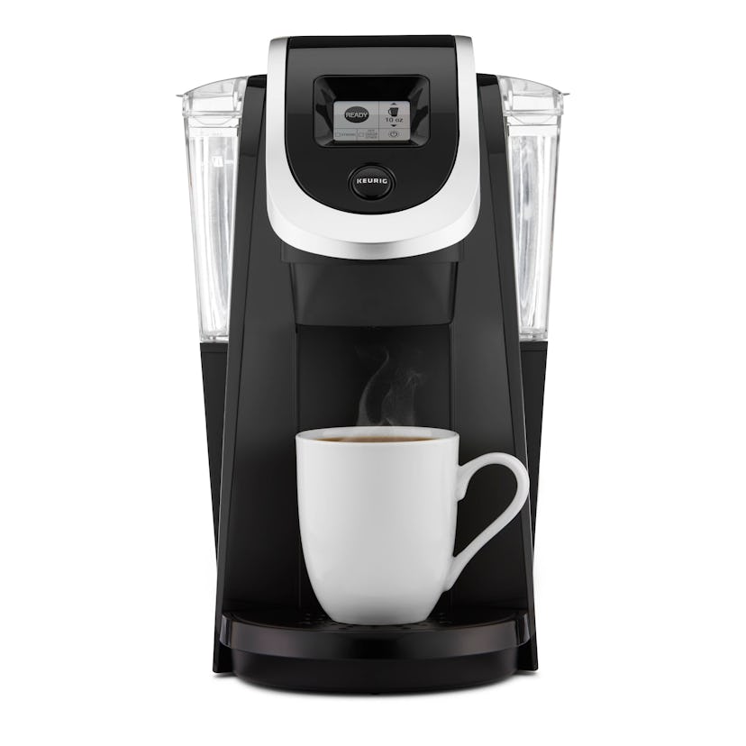 a black Keurig single-serve coffee machine and a mug full of freshly made coffee