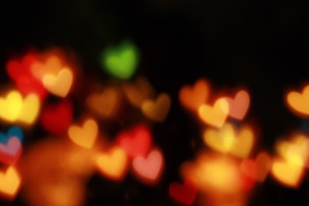Blurry multicolored hearts on a black background