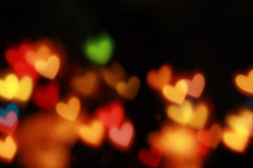Blurry multicolored hearts on a black background