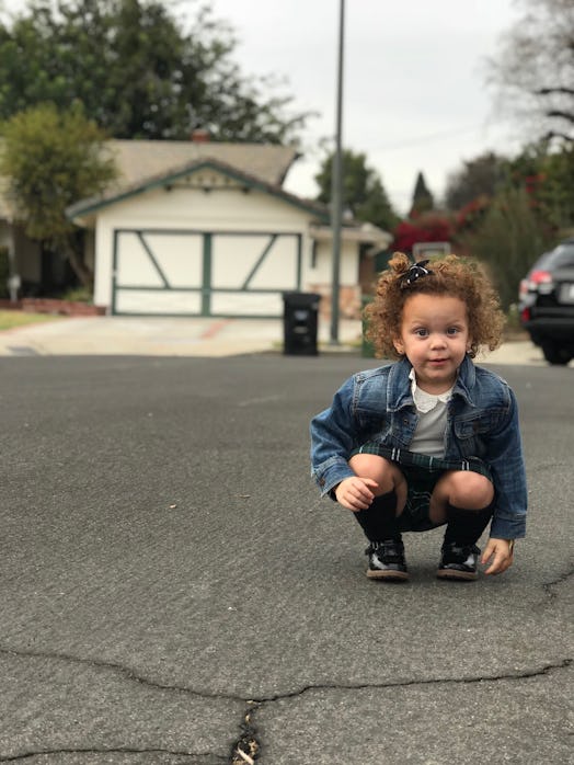 A little boy standing on a street