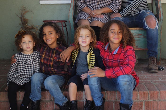 A group of kids sitting on a porch 
