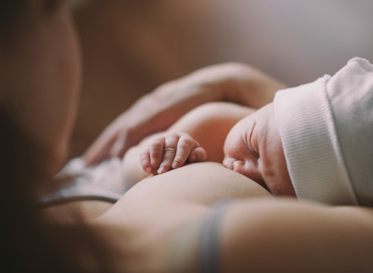 A baby on its mother chest, being breastfed