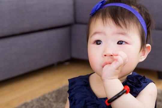 little girl sucking thumb