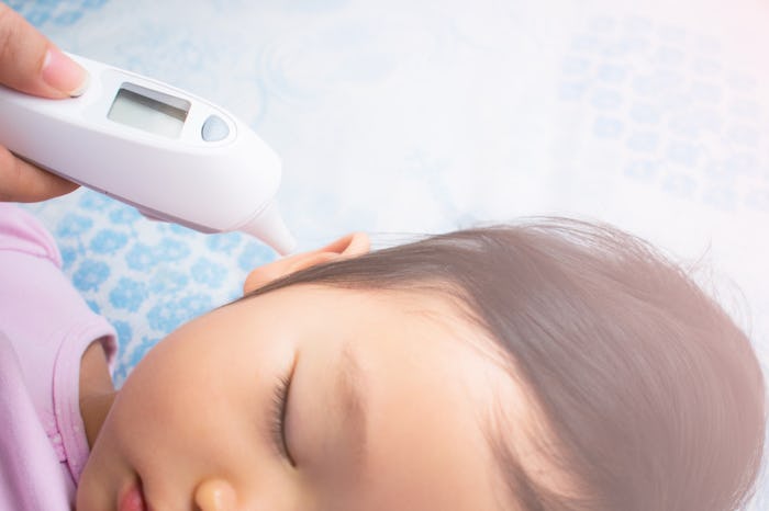 Mother checking her toddler's body temperature