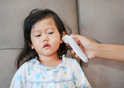 A parent clearing the ear of a child with ear infection