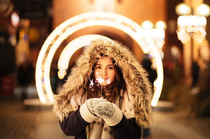 A woman holding a sprinkler on Christmas