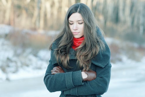 Young lady walking alone in a snowy environment coping with loneliness