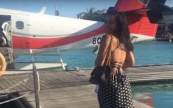 Tristan Thompson's ex-girlfriend, Jordan Craig smiling on a pier with a charter plane parked on the ...