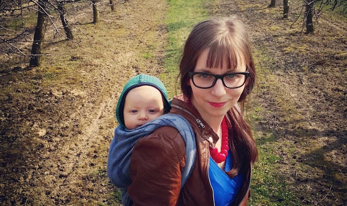 A mother carrying her baby on her back