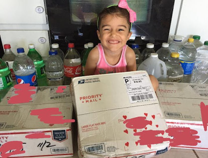 A girl holding a package for her family from Adopt A Family In PR organization