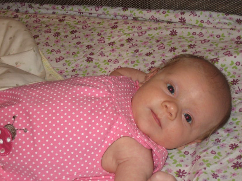 A picture of a baby girl in pink bodysuit 