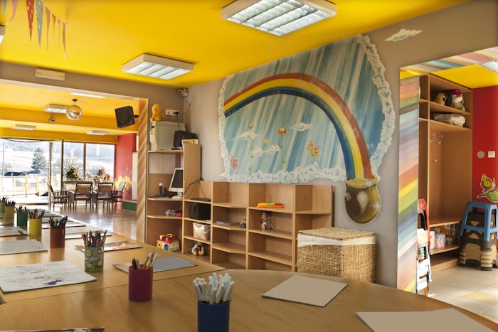 Inside of the room of a day care with a wall painted with rainbow 