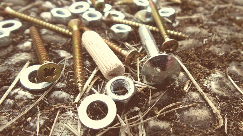 Screws and dowels lying on the ground