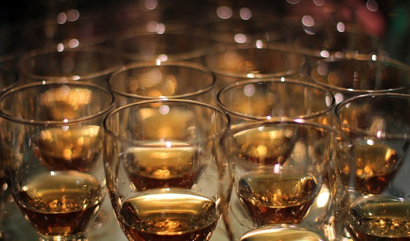 A picture of many glasses with bourbon in them