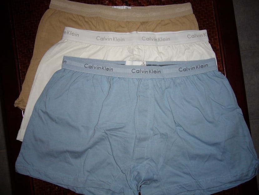 Three pairs of Calvin Klein underwear in beige, white and blue