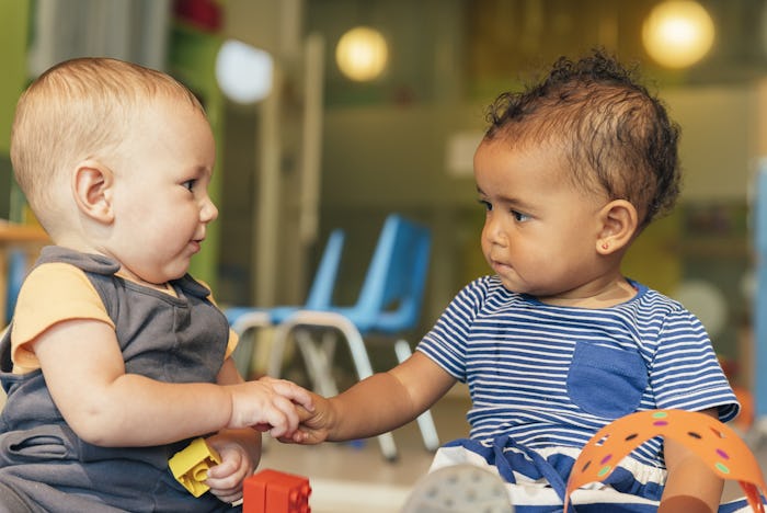 Two friendly baby boys playing together