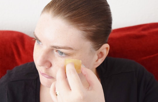 A woman trying the green ice tea cubes for under-eye circles hack