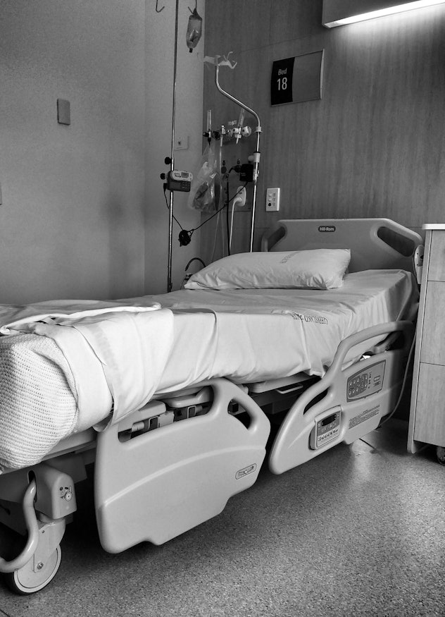A black and white photo of a hospital bed.