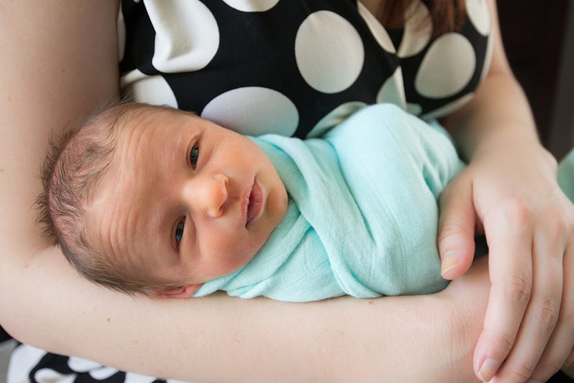 A mother holding her baby