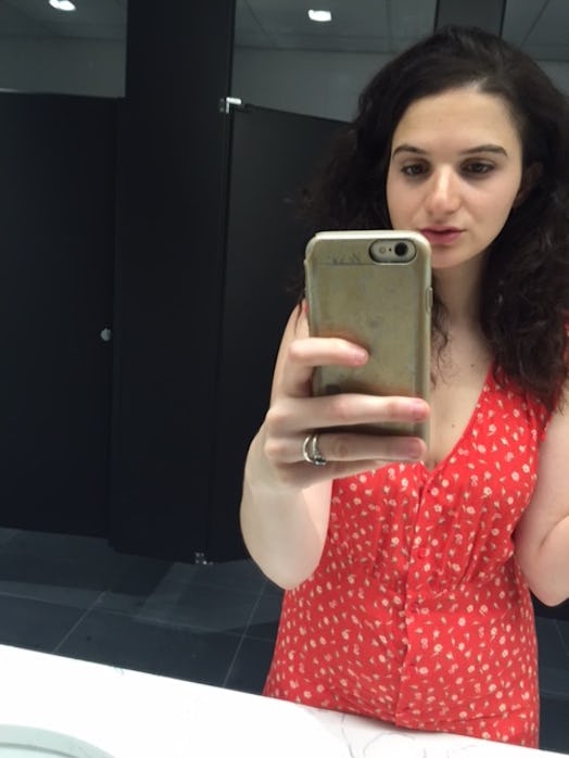Ej Dickson taking a selfie in the mirror while wearing a red dress