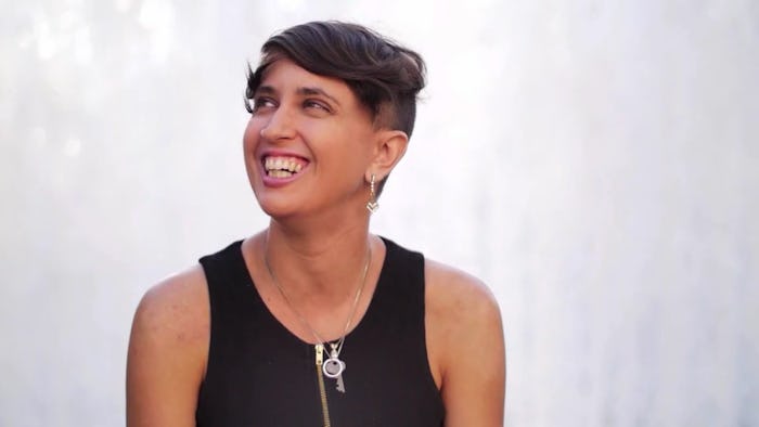 Woman with short hair smiling and looking on into the distance