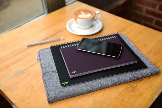 Two Rocketbook Wave smart, microwavable, magically erasing notebooks and a mobile phone