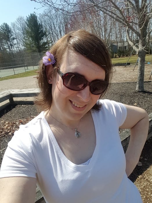 Katelyn Burns in the park with brown sunglasses and a purple flower in her hair
