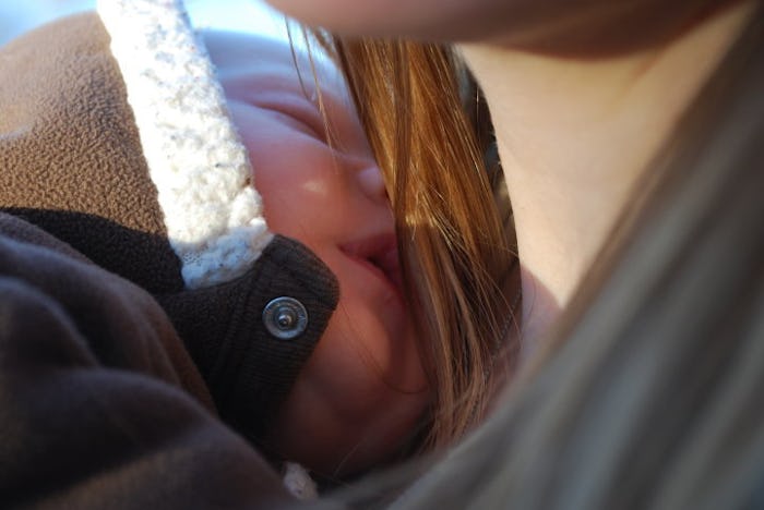 A baby sleeping on its mothers chest