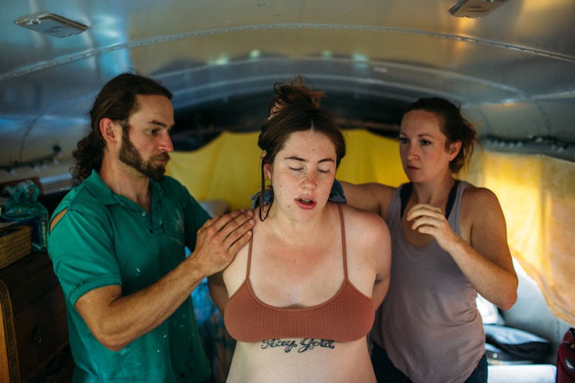 A woman preparing to give a birth on a school bus