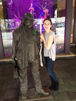 EJ Dickson standing next to a statue and smiling during the time when she didn't know she had an eat...