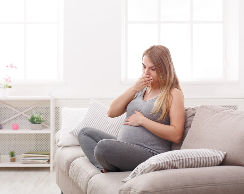 pregnant woman on couch feeling sick