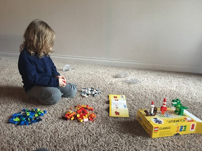 Elle Stangers' kid photographed while sitting on the floor and playing with toys