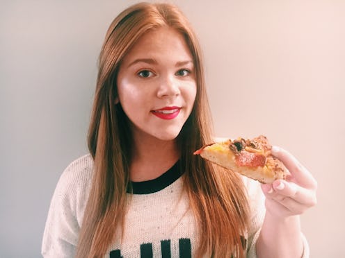A girl eating pizza while wearing a pizza-proof lipstick