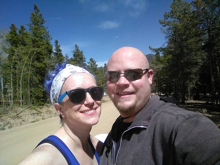 A married couple taking selfie postpartum while spending their day in the nature