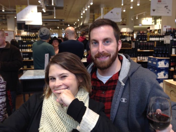 A couple posing for a picture in a store, both smiling and looking ahead of them