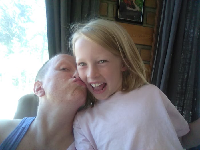 A trans child kissing its sister