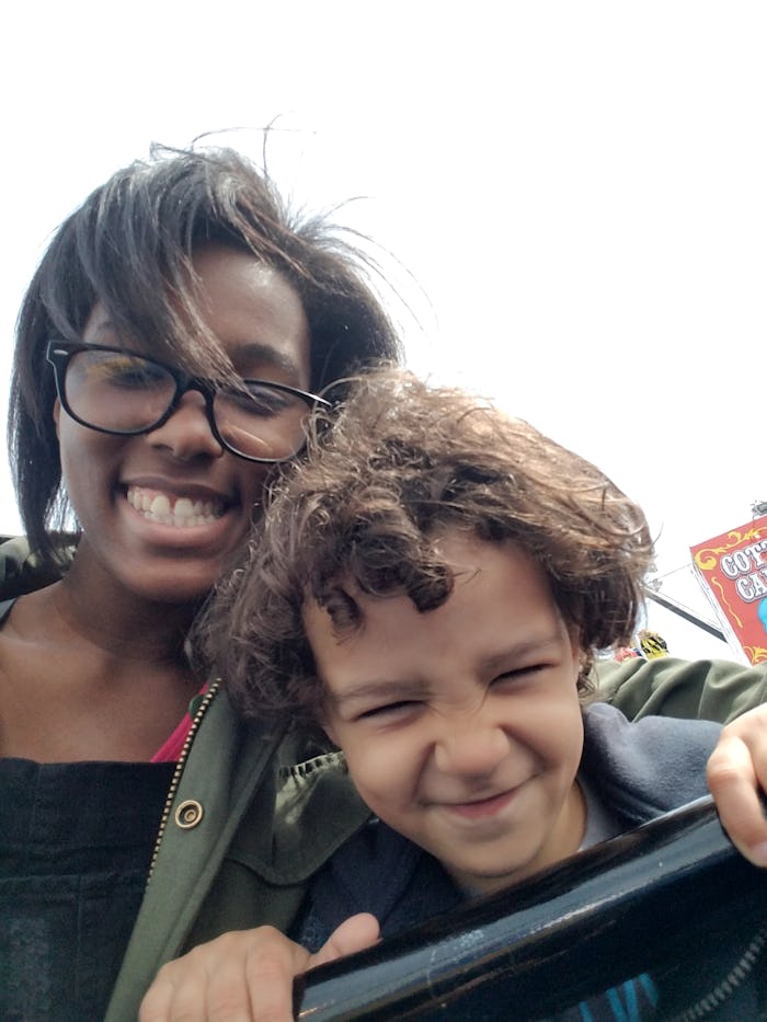 Sa'iyda Shabazz smiling while taking a selfie with her kid