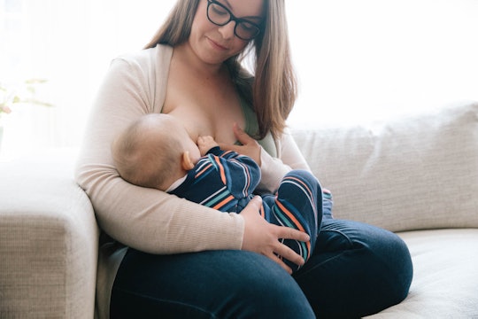 A mother with big boobs breastfeeding her child