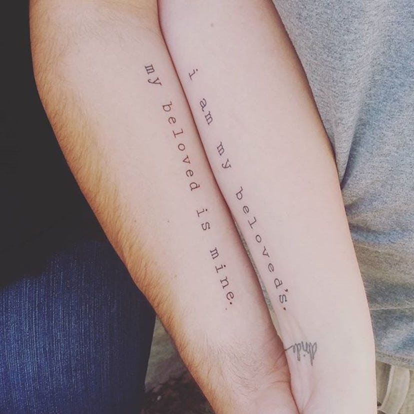 Man and woman with matching quote tattoos on their arms