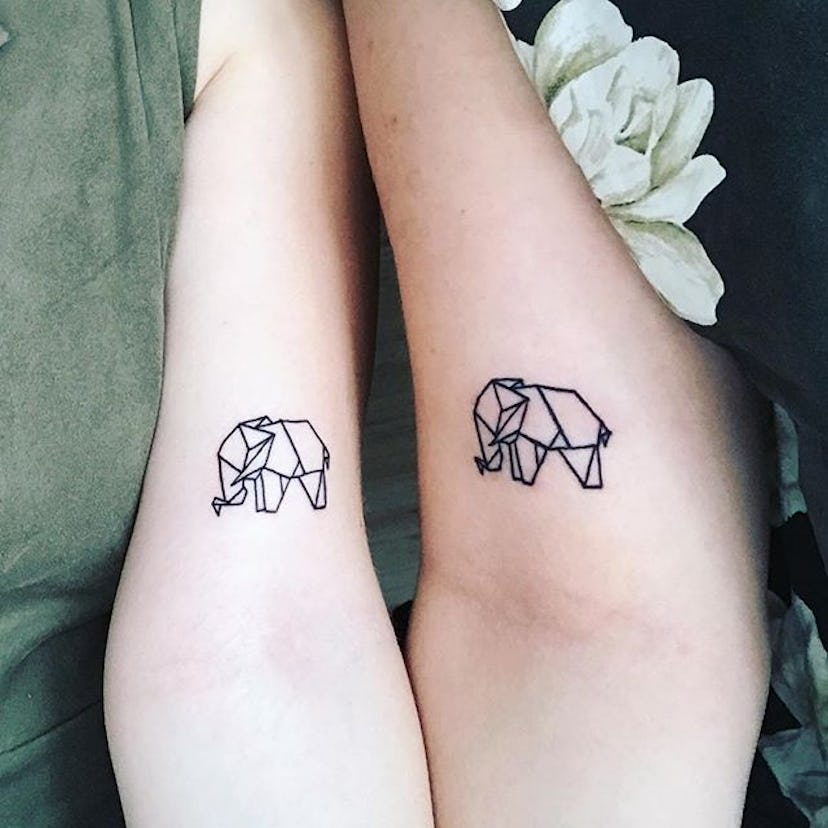 Two women with matching origami tattoos