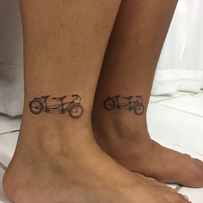 Man and woman with matching bikes tattoos on their ankles