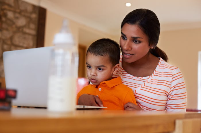 A mom with her kid in her lap, looking up advice on Facebook about getting the kid to stop throwing ...