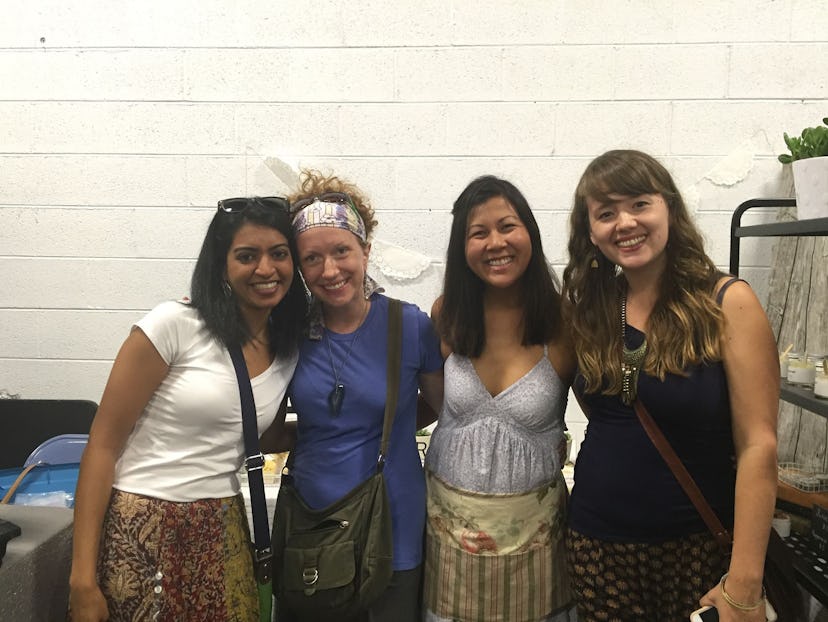 Four happy women are posing for a group photo.