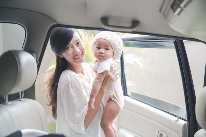 A mom and her newborn going out of the car depicting how mom-shaming can actually improve parenting