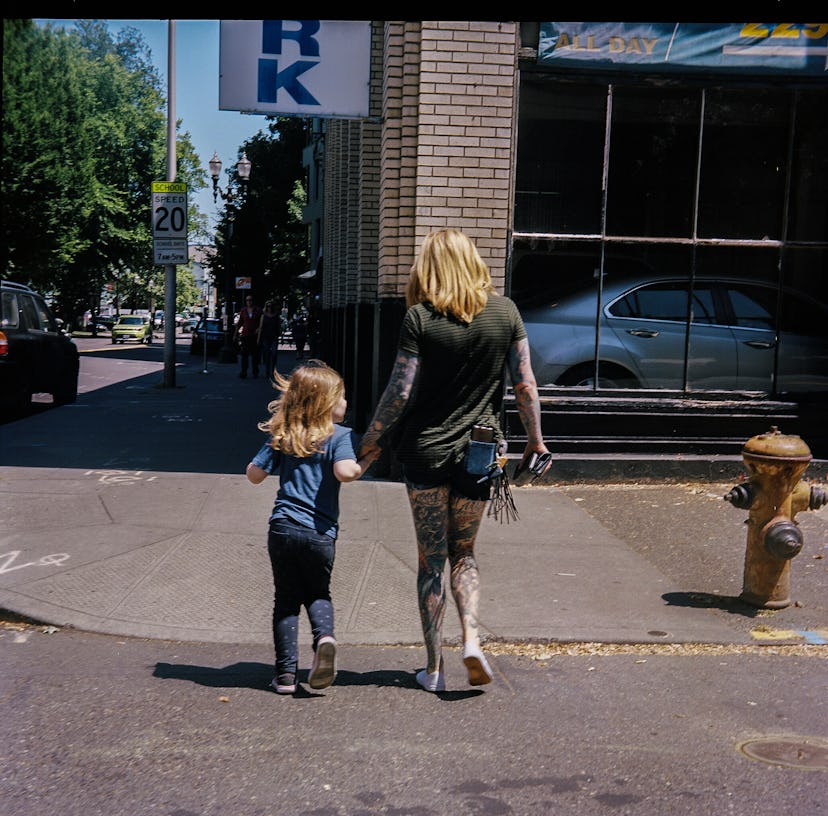 A mother crossing the street with her child 