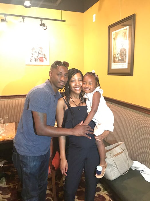 A couple and their child posing for a picture in the restaurant