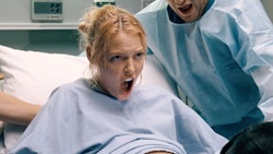 A pregnant woman screaming in the delivery room