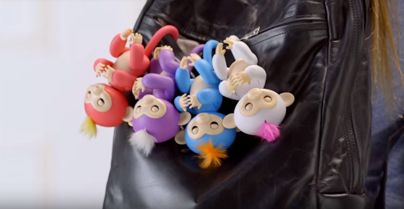 WowWee's Fingerlings Baby Monkeys hanged on a backpack